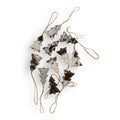 A set of ten unique black hair-on hide Christmas tree ornaments with natural jute hangers, arranged in a scattered layout.