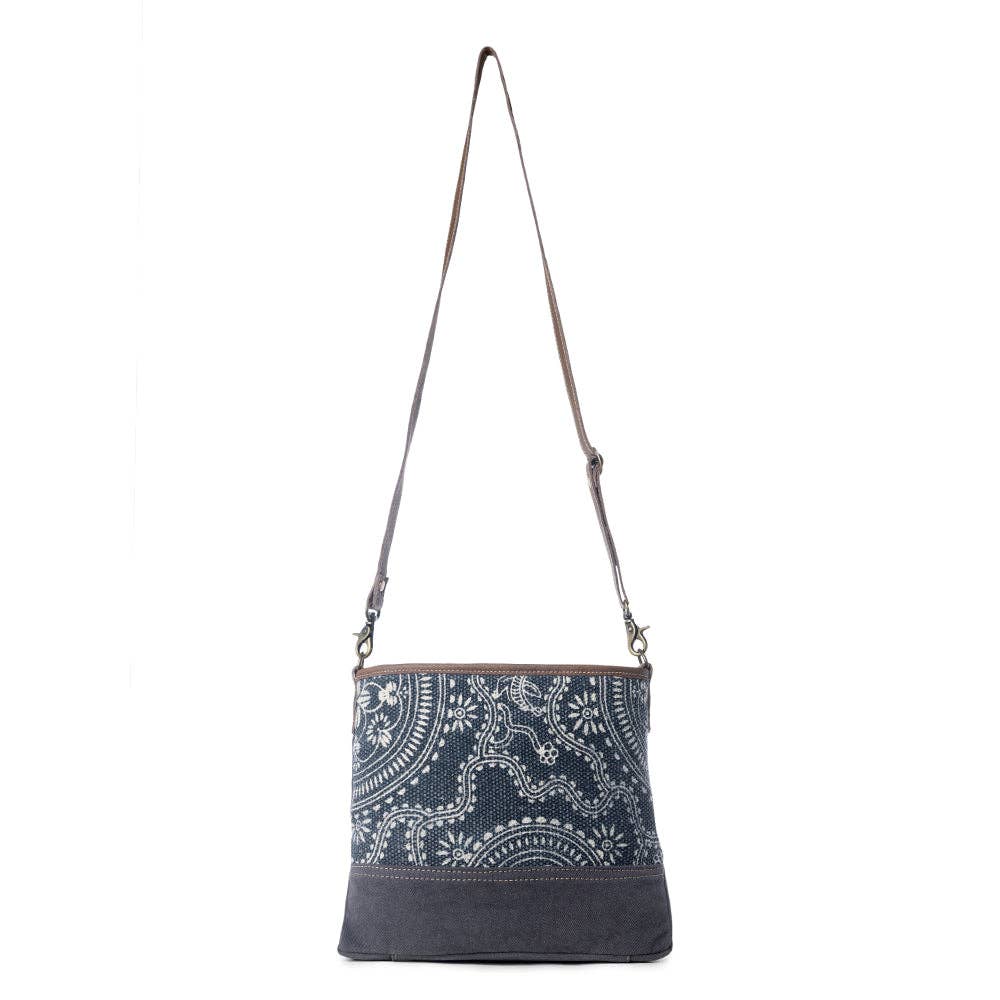 Navy shoulder bag featuring a classic kilim pattern and a comfortable strap for stylish travel and daily use.