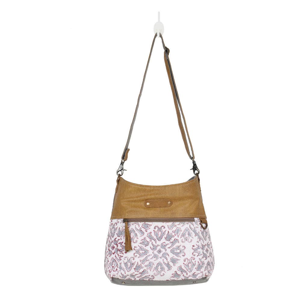 Shoulder bag featuring a colorful design, adjustable strap, and decorative tassel, perfect for stylish outings.