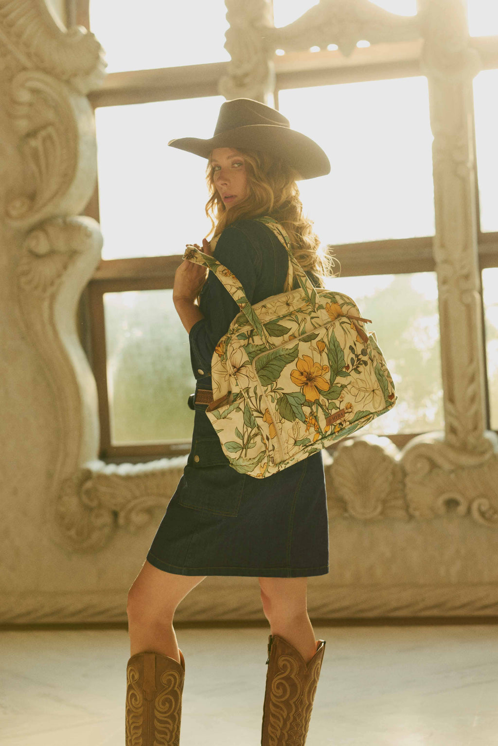 A structured Sunnyfield Cotton Diaper Bag in ochre fern with a vintage-inspired floral pattern and spacious main compartment.