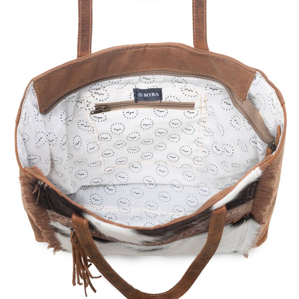 Spacious Oakley Specks Canvas & Hairon Bag featuring fringe detailing and a zippered pocket inside. Perfect for any occasion.