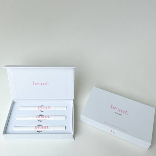 Three white smile pens in a white box with pink text, designed for teeth whitening treatments.