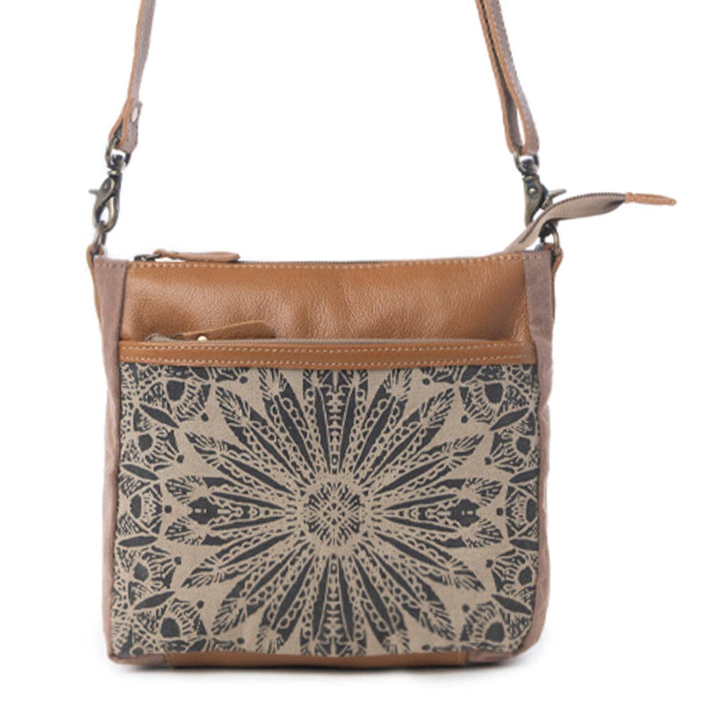 Tan and patterned Dizzy Circle small crossbody bag featuring a front pocket and a shoulder strap, made from canvas and leather.