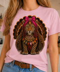 A light pink crew t-shirt featuring a jeweled collar turkey leopard design with vibrant colors and embellishments.