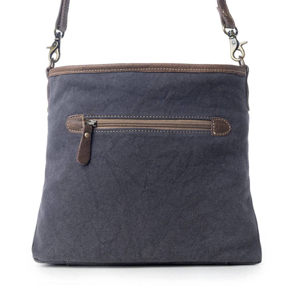 Navy shoulder bag featuring a classic kilim pattern, zippered front pocket, and sturdy rectangular shape.