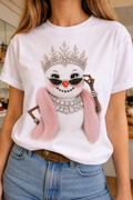 A white crew t-shirt featuring a jeweled collar snow lady in sunglasses with a pink fur stole and sparkling embellishments.