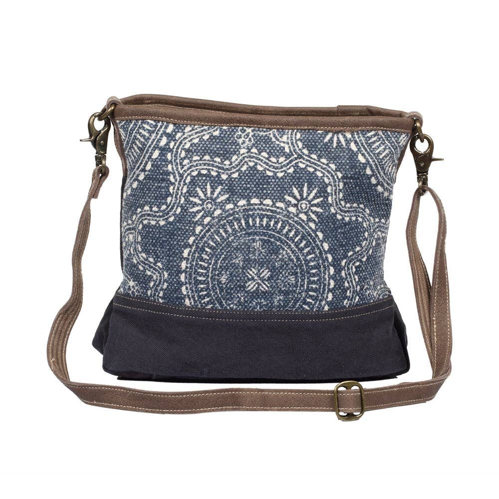 Navy kilim shoulder bag with a contrasting solid navy bottom, featuring a zippered top closure and a slouchy design.