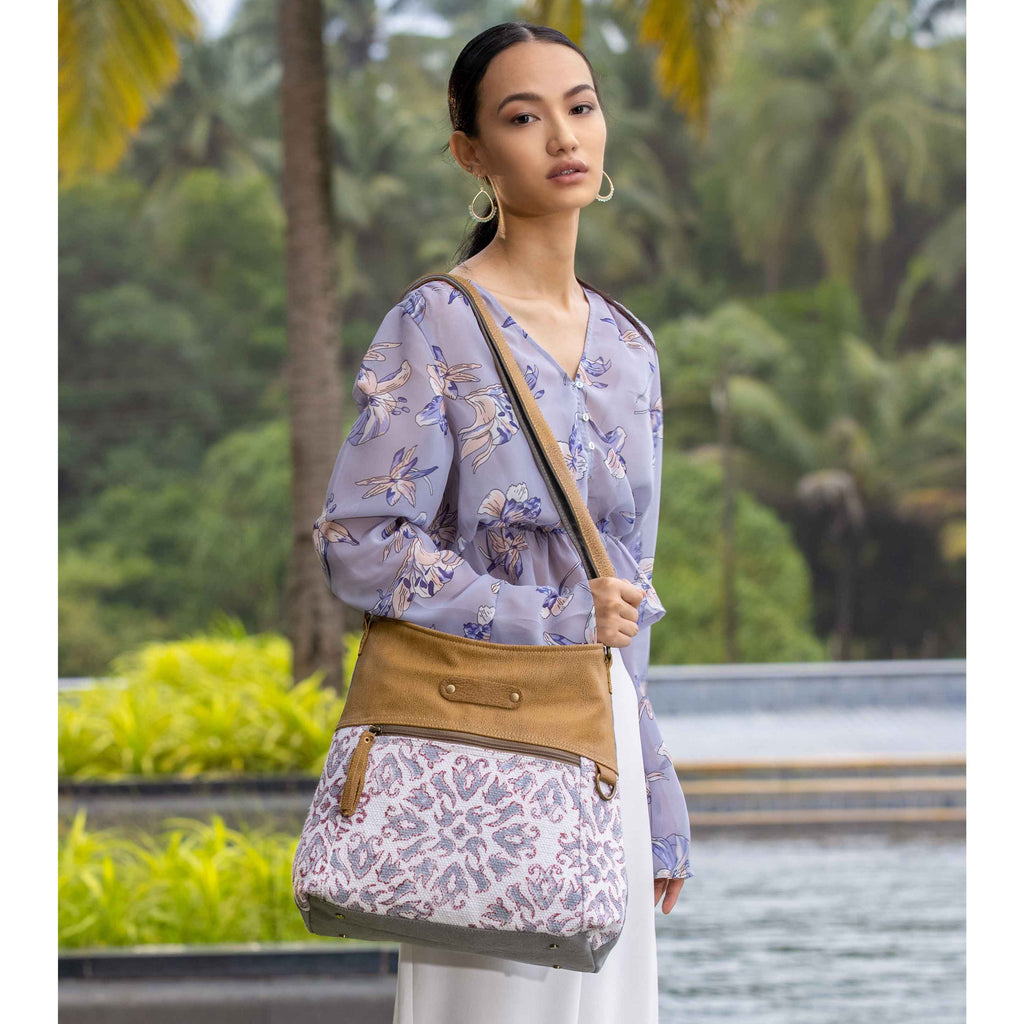 Shoulder bag featuring a vibrant color scheme with a patterned design and solid top, adjustable strap, and thoughtful pockets.