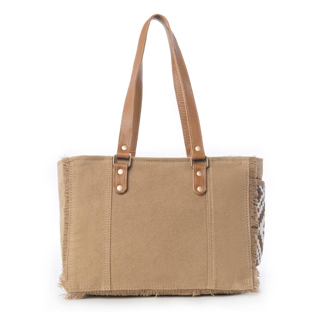 Tan crossbody bag with fringe detail, featuring two handles and a stylish rectangular shape, perfect for any occasion.