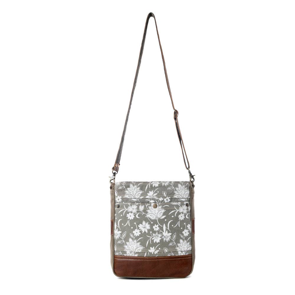 Blossom print shoulder bag featuring a canvas-like texture, flap closure, and a stylish leather bottom. Perfect for everyday errands.