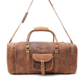 Amber brown leather traveller bag with a structured design, front pocket with buckle closure, and detachable shoulder strap.