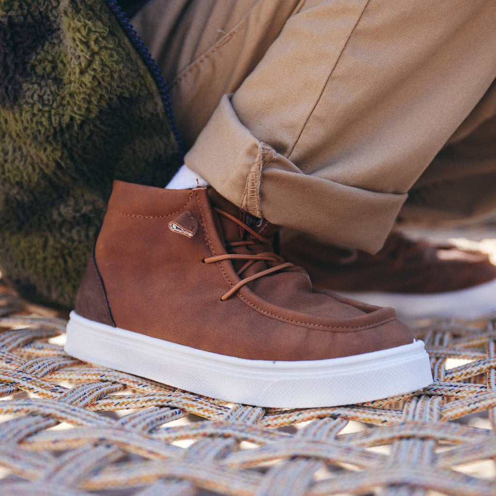 Brown Cole Young Boys Slip-On Shoe featuring elastic laces and a soft lining, perfect for school and play.