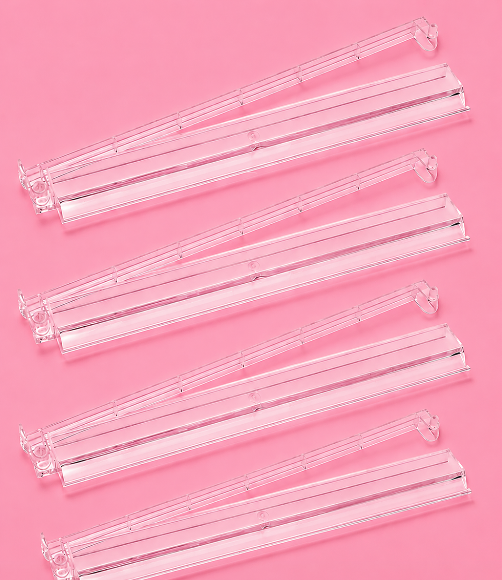 Clear Mahjong tile racks arranged in a row, featuring pushers for easy gameplay and organization. Perfect for game nights.