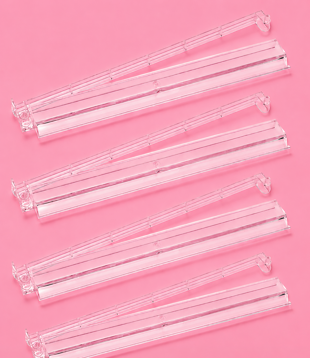 Clear Mahjong tile racks arranged in a row, featuring pushers for easy gameplay and organization. Perfect for game nights.