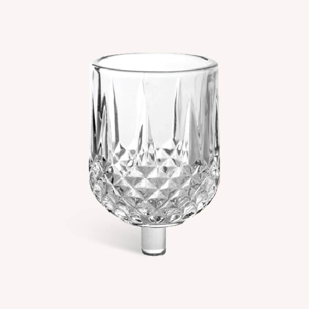 Clear glass cup with a textured base, part of the Ner Mitzvah Crystal Oil Glass Cups 9-pack for Chanukah.