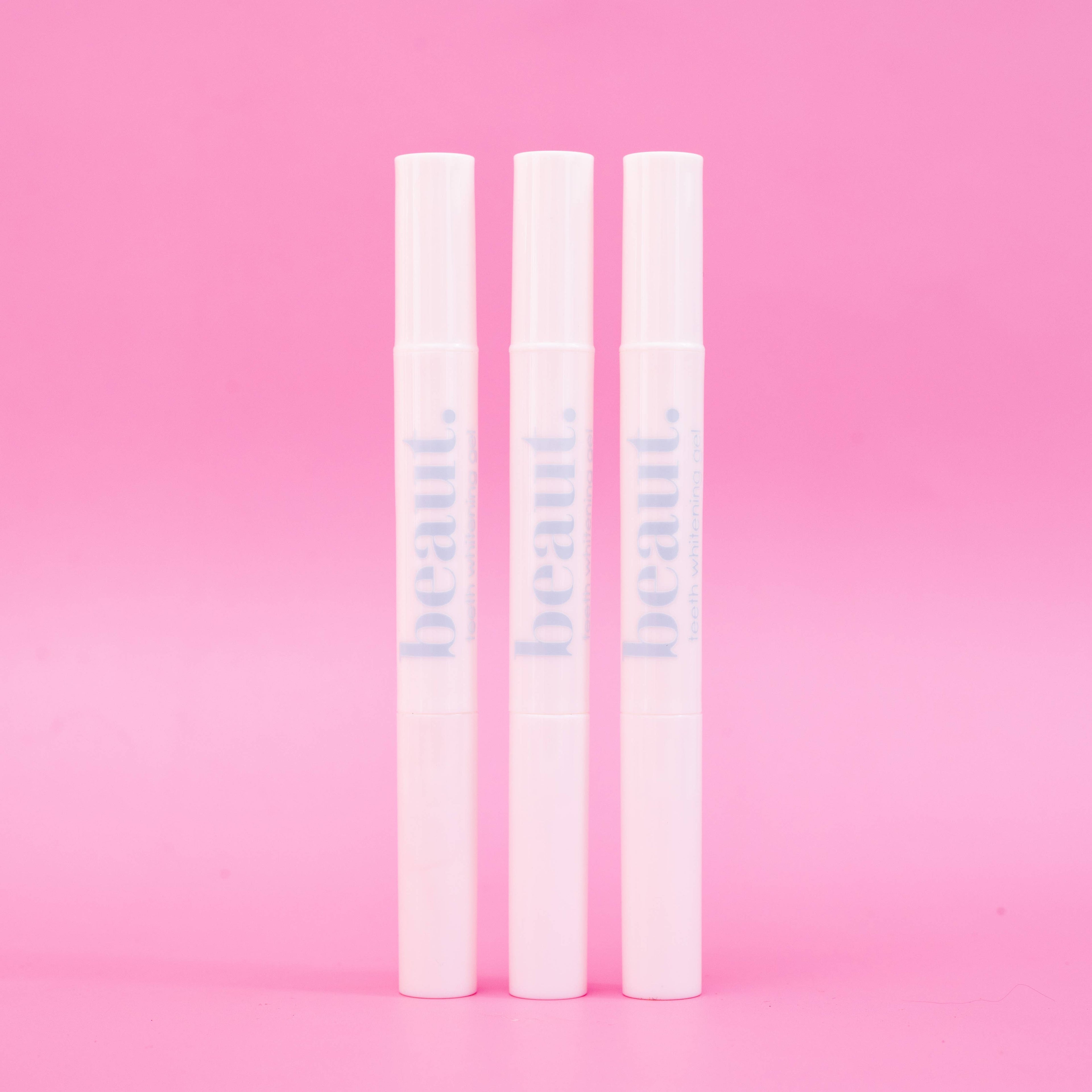 Three white applicator pens for the Cozy Kit, designed for whitening and oral care treatments.