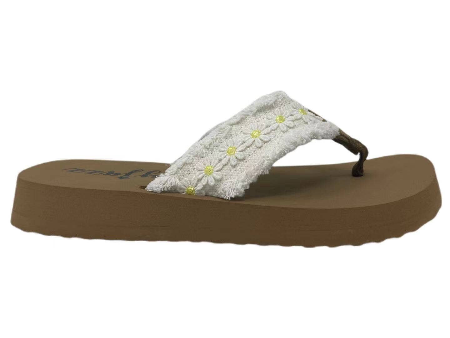 Flip-flop style sandal with a thick sole and daisy-adorned strap, perfect for summer outings.