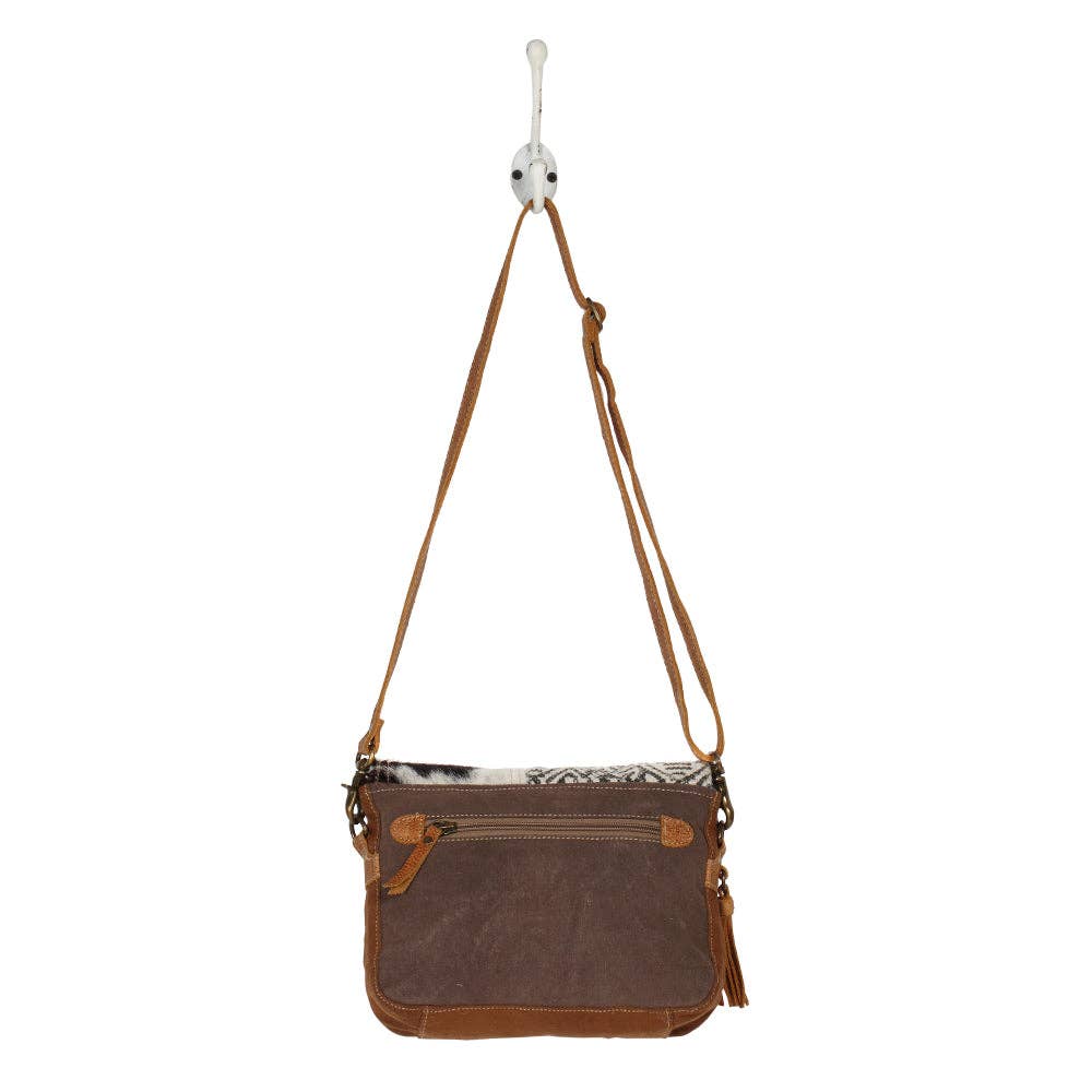 Tan leather shoulder strap messenger bag featuring a geometric design and a hairon cowhide flap panel.