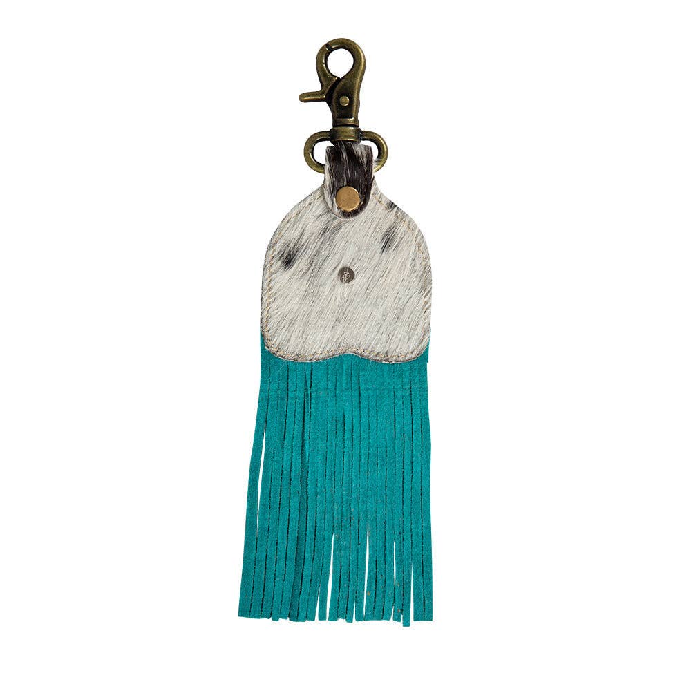Fringed key fob featuring hair-on hide with turquoise fringe and a metal clip for easy attachment.