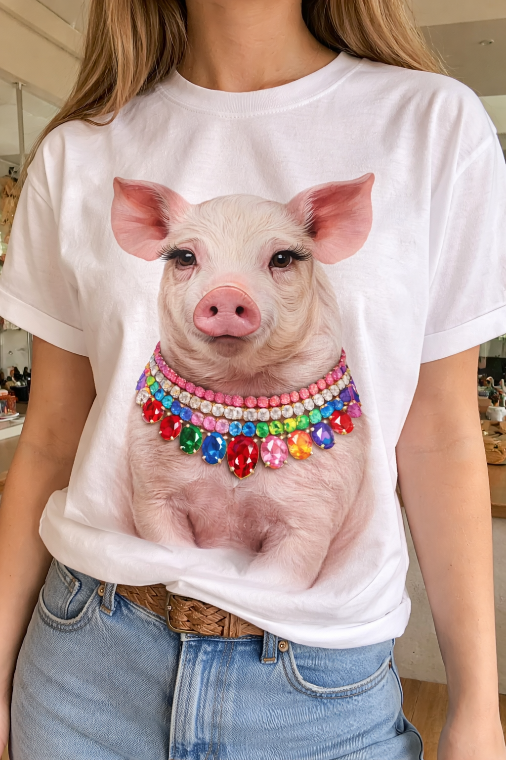 A jeweled collar show pig graphic on a white t-shirt, featuring colorful jewels around its neck for added sparkle.