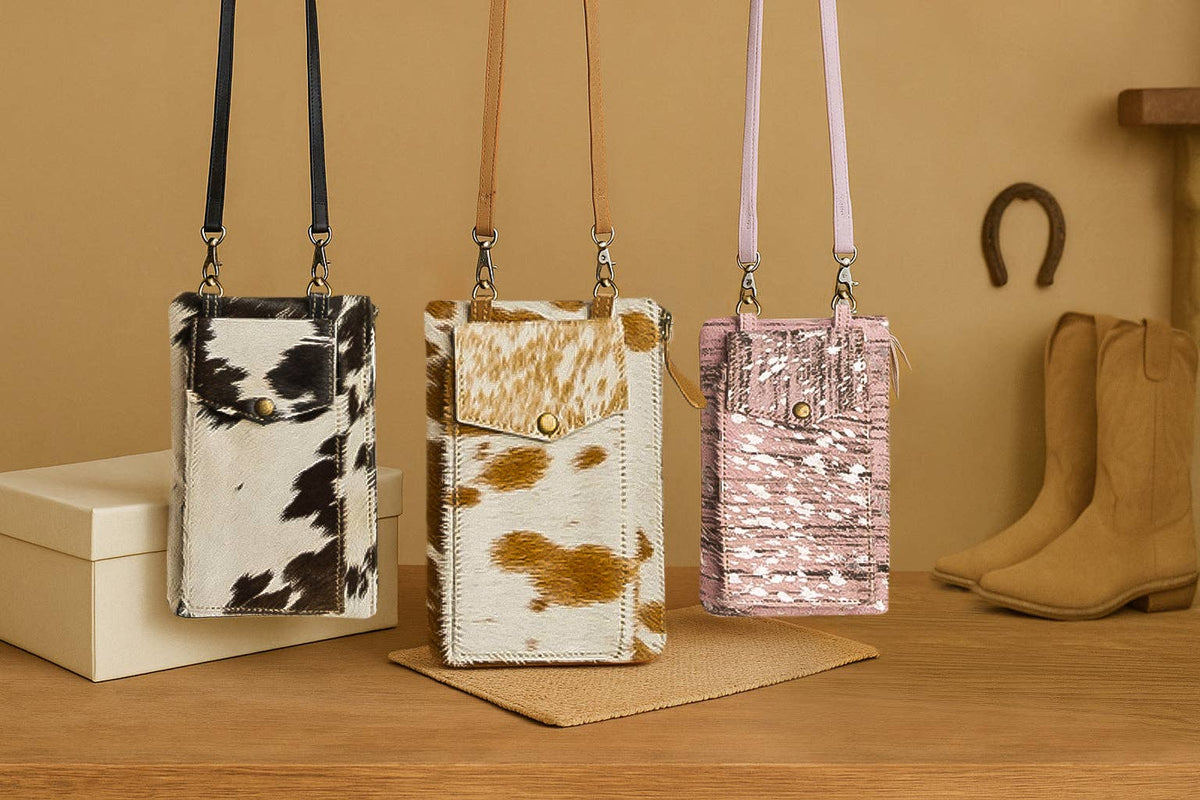 Three stylish phone case bags in black and white, brown and white, and pink, featuring front pockets and adjustable straps.