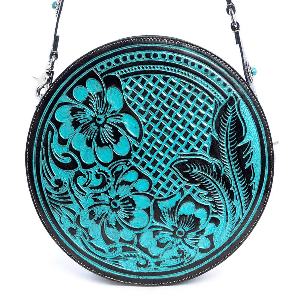 Round handbag featuring hand-tooled turquoise and ebony design with floral patterns and a zippered pocket on the back.