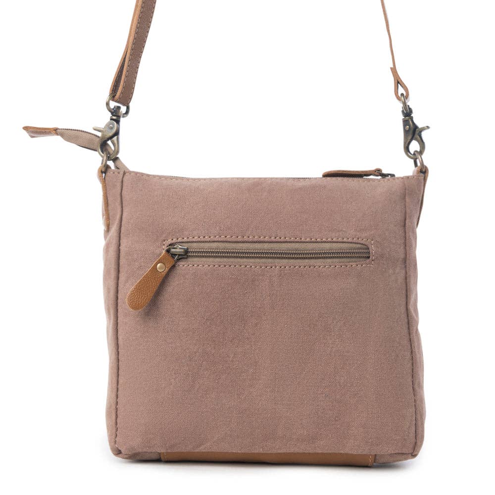 Small crossbody bag in muted tones with a front zip pocket and shoulder strap, perfect for carrying essentials.