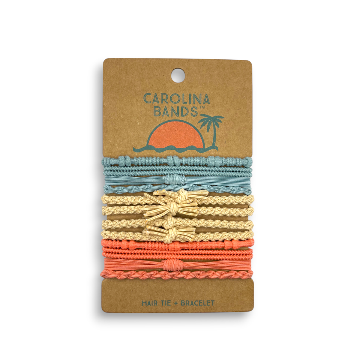 A set of Carolina Bands hair tie bracelets in coastal colors, featuring blue, beige, and coral, displayed on a palm tree graphic backing.