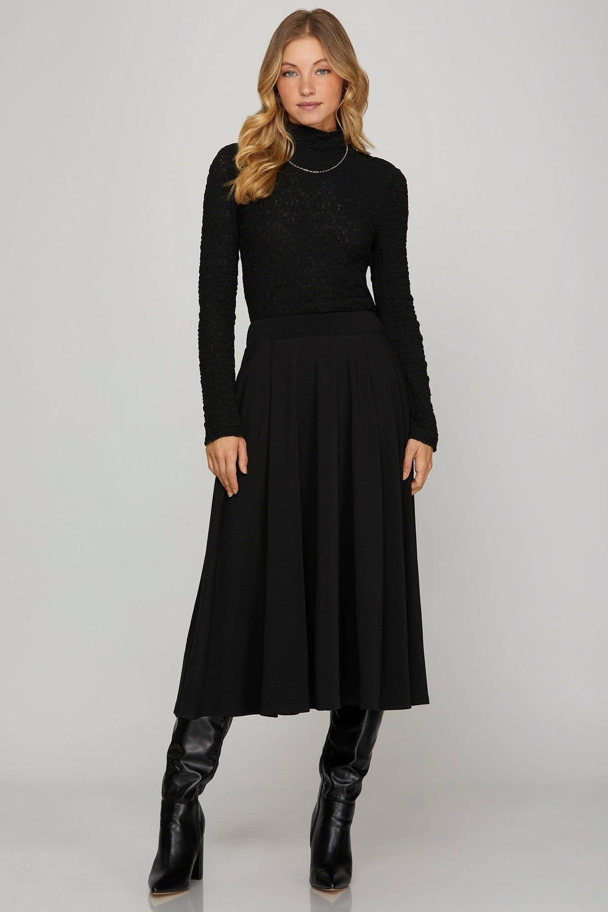 Black flared midi skirt with pleated design, perfect for formal or semi-formal occasions. Features pockets for added convenience.
