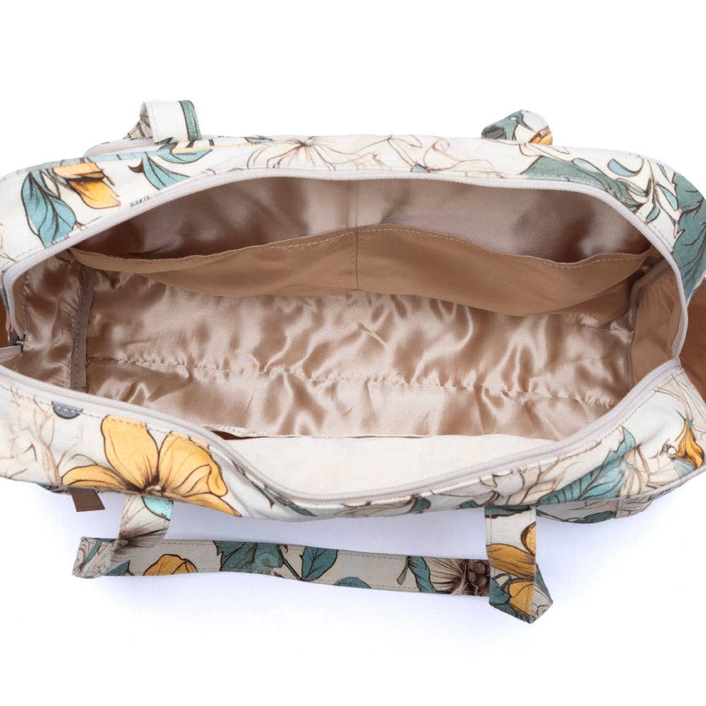 Spacious Sunnyfield Cotton Diaper Bag in ochre fern with a vintage-inspired floral pattern and structured handles.