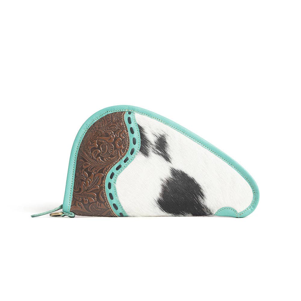 Turquoise-trimmed leather gun case with hand-tooled panel and black-and-white hairon design, featuring a wrap-around zipper.