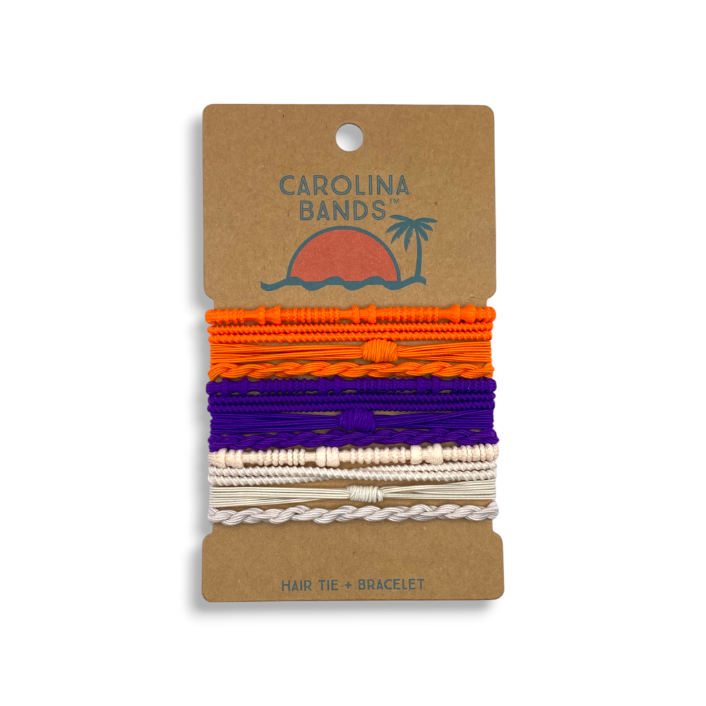 A set of colorful hair tie bracelets in orange, purple, and white, featuring a sun and palm tree graphic on the backing.