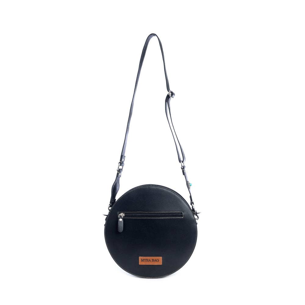Round handbag featuring a hand-tooled turquoise and ebony design, with a zippered pocket and adjustable shoulder strap.