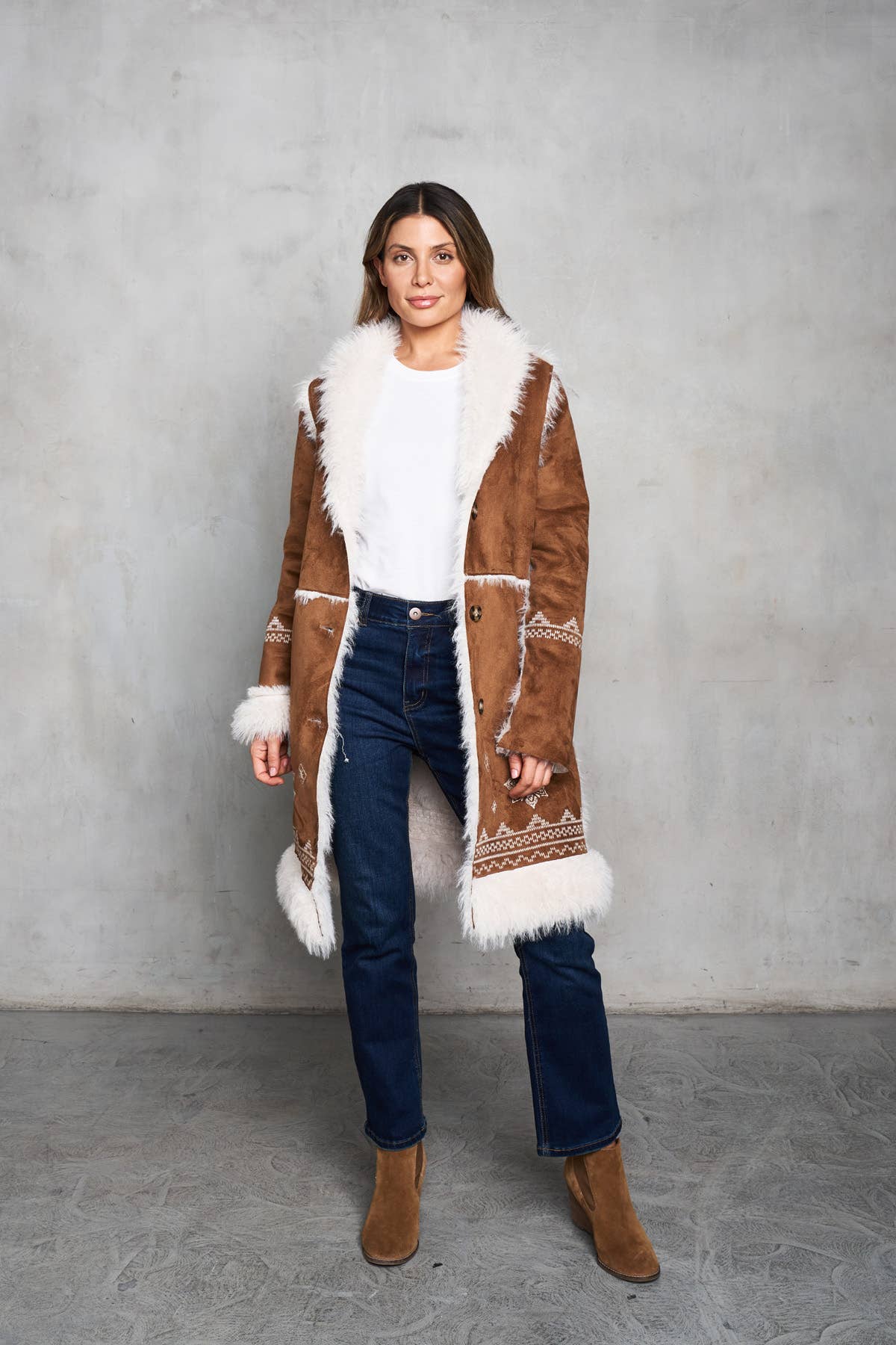 Faux suede camel coat featuring shearling trim and delicate embroidery on the front and sleeves. Perfect for a Western style.