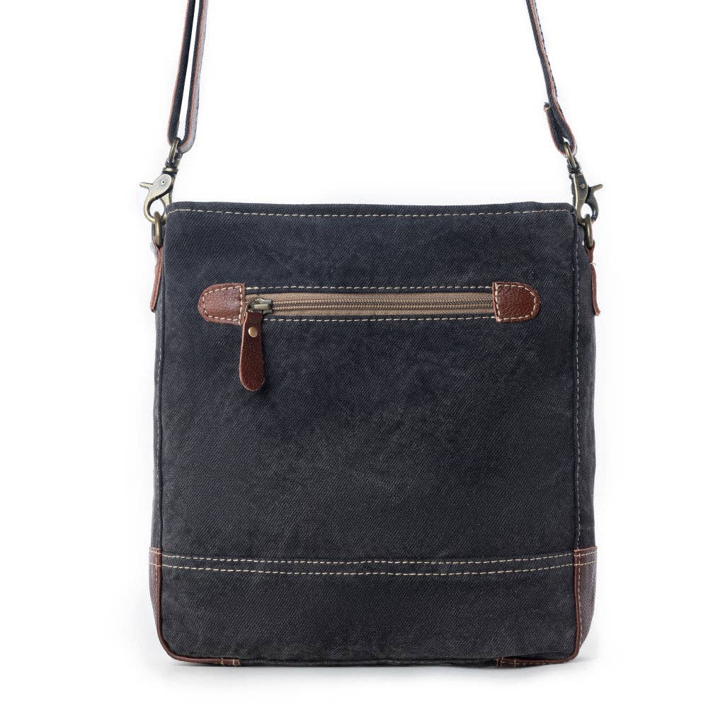 Stylish shoulder bag featuring a dark exterior, contrasting leather accents, and a zippered front pocket.