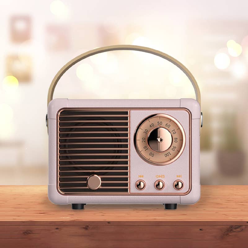 Retro mini wireless Bluetooth speaker with a front speaker grille, large dial, and control buttons in a stylish design.