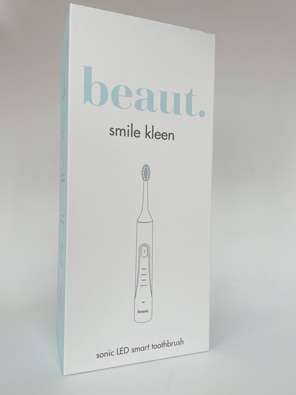 Sleek Smile Kleen Sonic Vibration Toothbrush in packaging, showcasing its design and control buttons for a modern dental care experience.