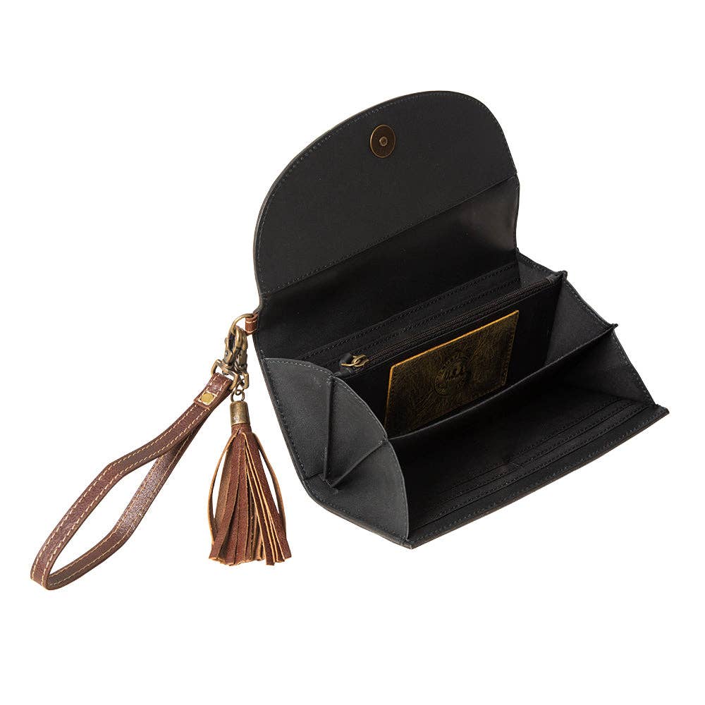 Hand-tooled wristlet wallet with a zippered pocket and spacious sections, featuring a snap-close front flap and leather wristlet strap.