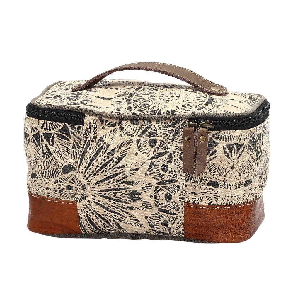 Floral design canvas and leather shaving kit with a wide mouth opening and secure zippered closure.