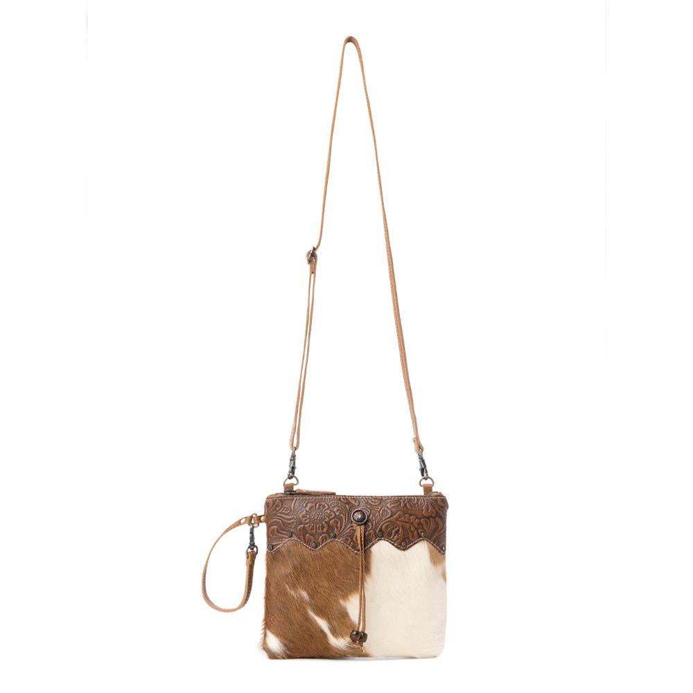 Ornate brown leather and hairon handbag with adjustable strap and strong back zipper, perfect for everyday style.