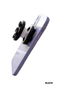 Suction cup phone grip in black and white design, showcasing its placement on a smartphone.