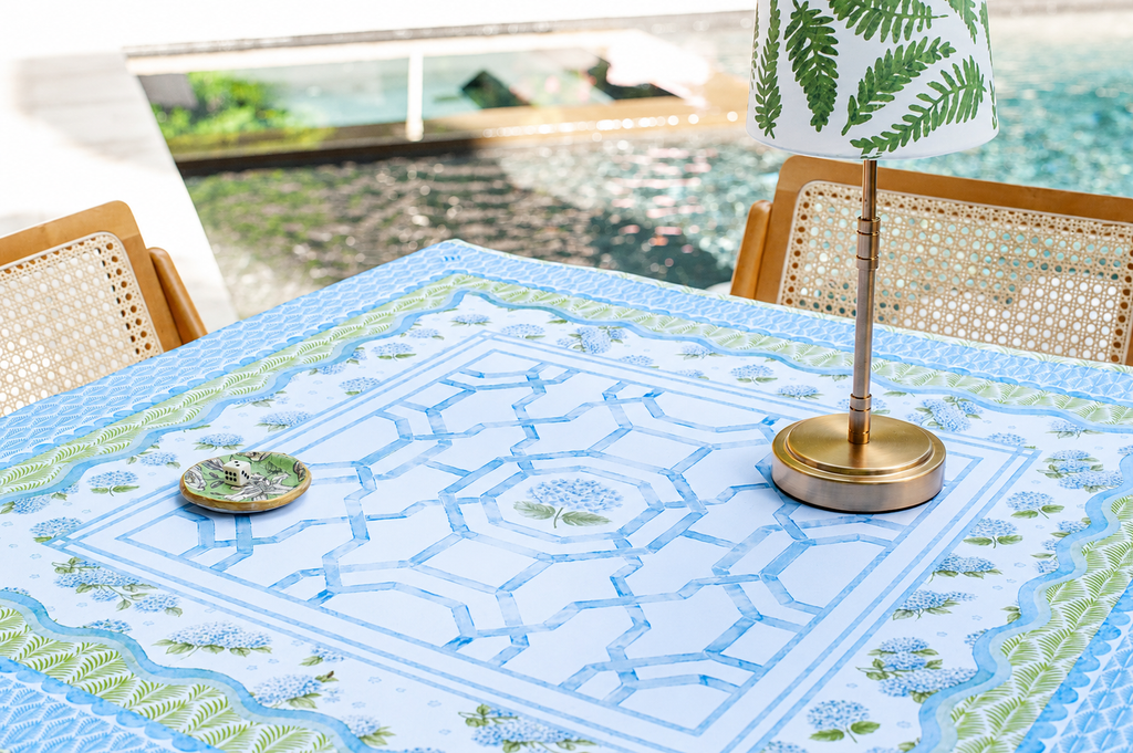 A floral Mahjong mat featuring soft blue colors and elegant lattice patterns with a scalloped edge.