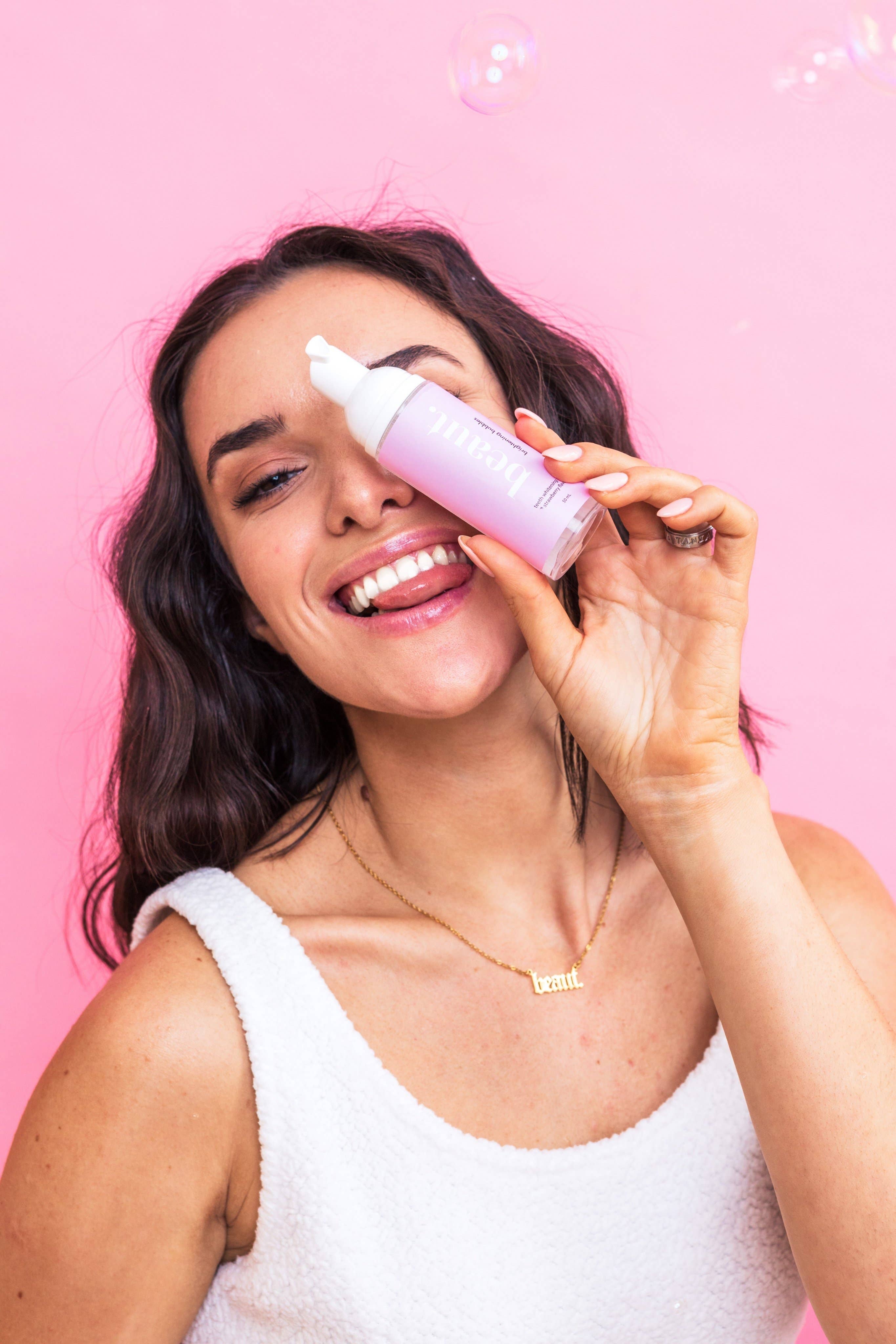Brightening Bubbles in a pink bottle with a pump dispenser, perfect for maintaining pearly whites and enhancing your smile.