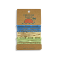 A set of Carolina Bands hair tie bracelets in blue, yellow, and green with various textures and patterns. Perfect for everyday wear.