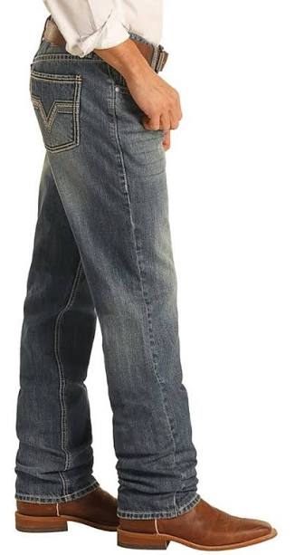 Dark vintage jeans with a stackable design draping over brown cowboy boots, featuring visible stitching and back pockets.