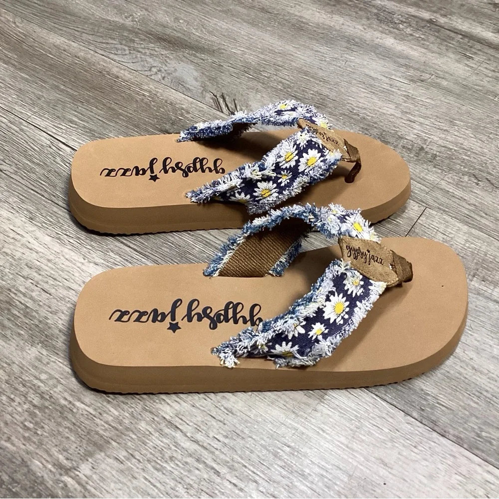 Floral-patterned blue and white Gypsy Jazz Sandal with fabric overlay straps and a flat sole. Perfect for summer outings.