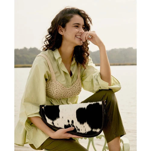 Stylish black and white gun cover bag with dark brown outlining, featuring a curved clutch design.